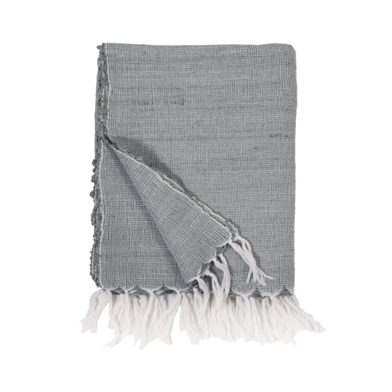 Gray woven blanket with white tassels on a white background