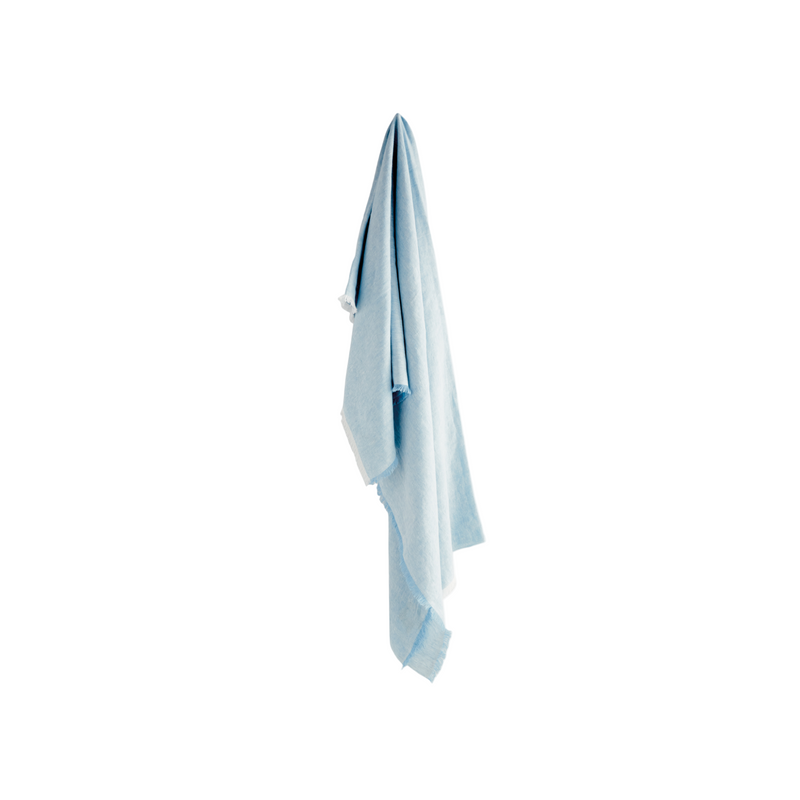 Light blue towel hanging on a white wall