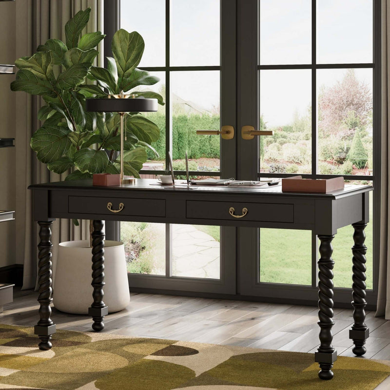 Decorative table with plant in a room with large windows and a patterned rug.